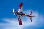 CKAero Alchemy Bipe F3A aerobatic biplane in flight against dramatic blue sky hero image