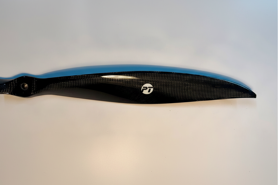 PT Model 23x20 front contra carbon fibre propeller blade close-up showing carbon weave texture, leading edge profile and PT Model logo on white studio background