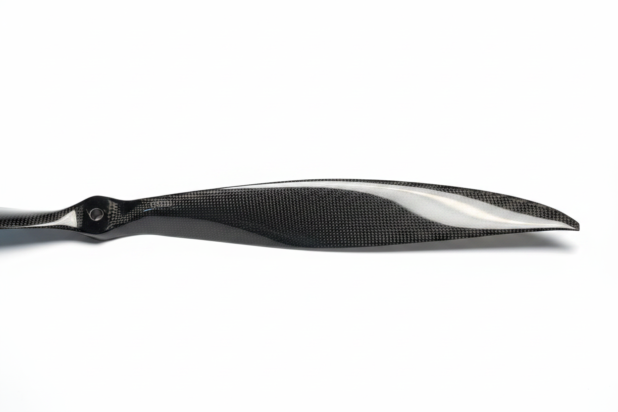PT Model 23x20 front contra carbon fibre propeller single blade close-up landscape view showing carbon weave texture and leading edge profile on white studio background